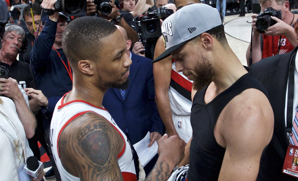 Damian Lillard congratulates Stephen Curry on advancing to a fifth straight NBA Finals. (AP)