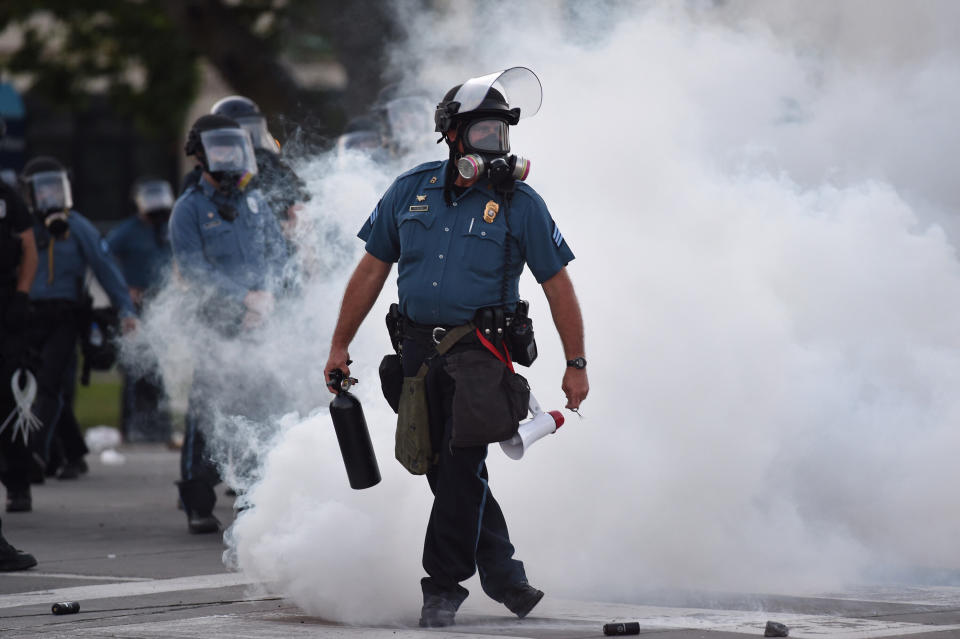 Law enforcement officers stand guard after tear gas is deployed near 47th and Main streets in Kansas City, Missouri, on May 31. (Photo: Kansas City Star via Getty Images)