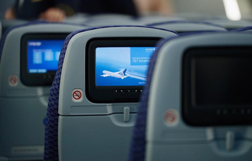 LOS ANGELES, CA - NOVEMBER 30: The United Airlines Economy Class with personal entertainment systems, with 13 languages available, is seen on the new Boeing 787 Dreamliner at Los Angeles International Airport on November 30, 2012 in Los Angeles, California. In January the new jet is scheduled to begin flying daily non-stop between Los Angeles International airport and Japan's Narita International Airport and later to Shanghai staring in March. The new Boeing 787 Dreamliner will accomodate 219 travelers with 36 seats in United Business First, 70 seats in Economy Plus and 113 in Economy Class. The carbon-fiber composite material that makes up more than 50 percent of the 787 makes the plane more fuel-efficient. (Photo by Kevork Djansezian/Getty Images)