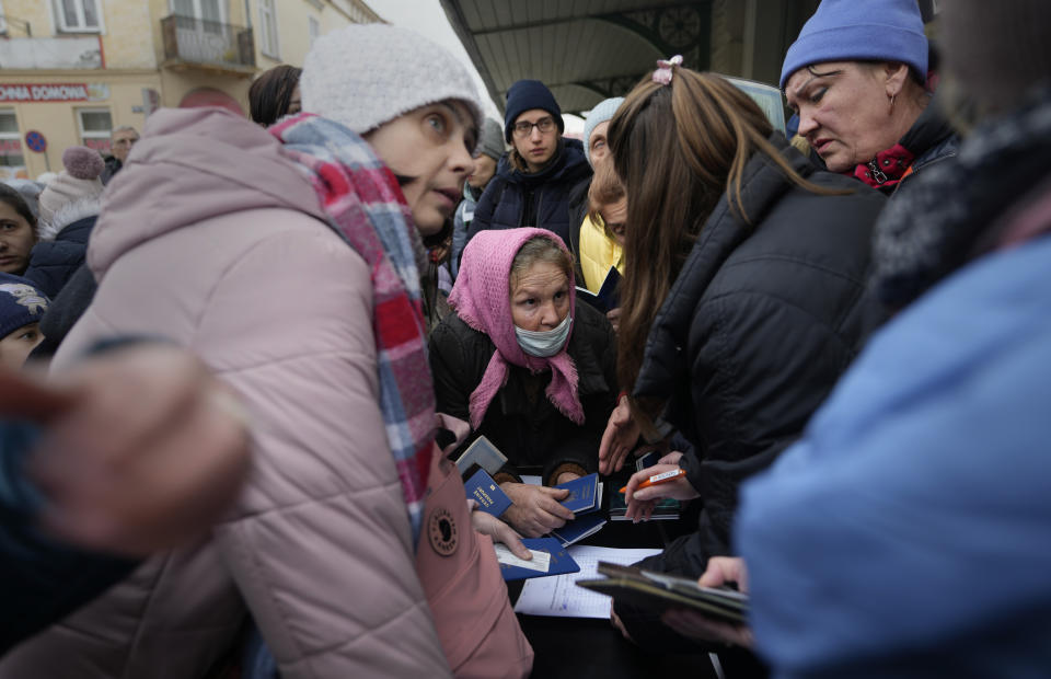 People fleeing Ukraine register for a bus that will take them to Germany at the train station in Przemysl, Poland.