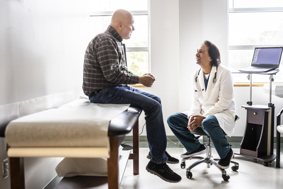 Doctor and senior discuss treatment in the examination room