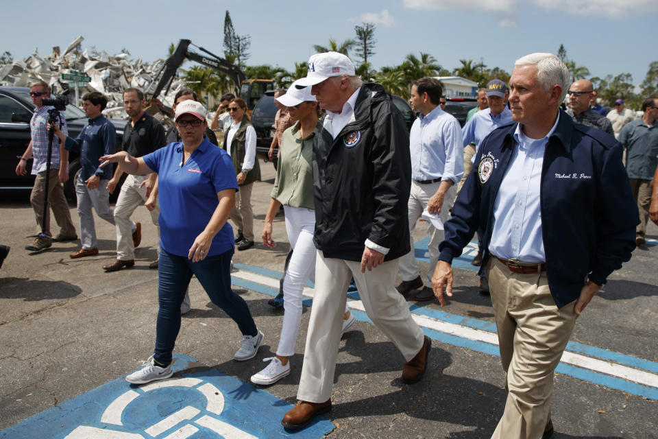 <p>President Donald Trump, first lady Melania Trump and Vice President Mike Pence, right, tour Naples Estates, a neighborhood impacted by Hurricane Irma, Thursday, Sept. 14, 2017, in Naples, Fla. (Photo: Evan Vucci/AP) </p>