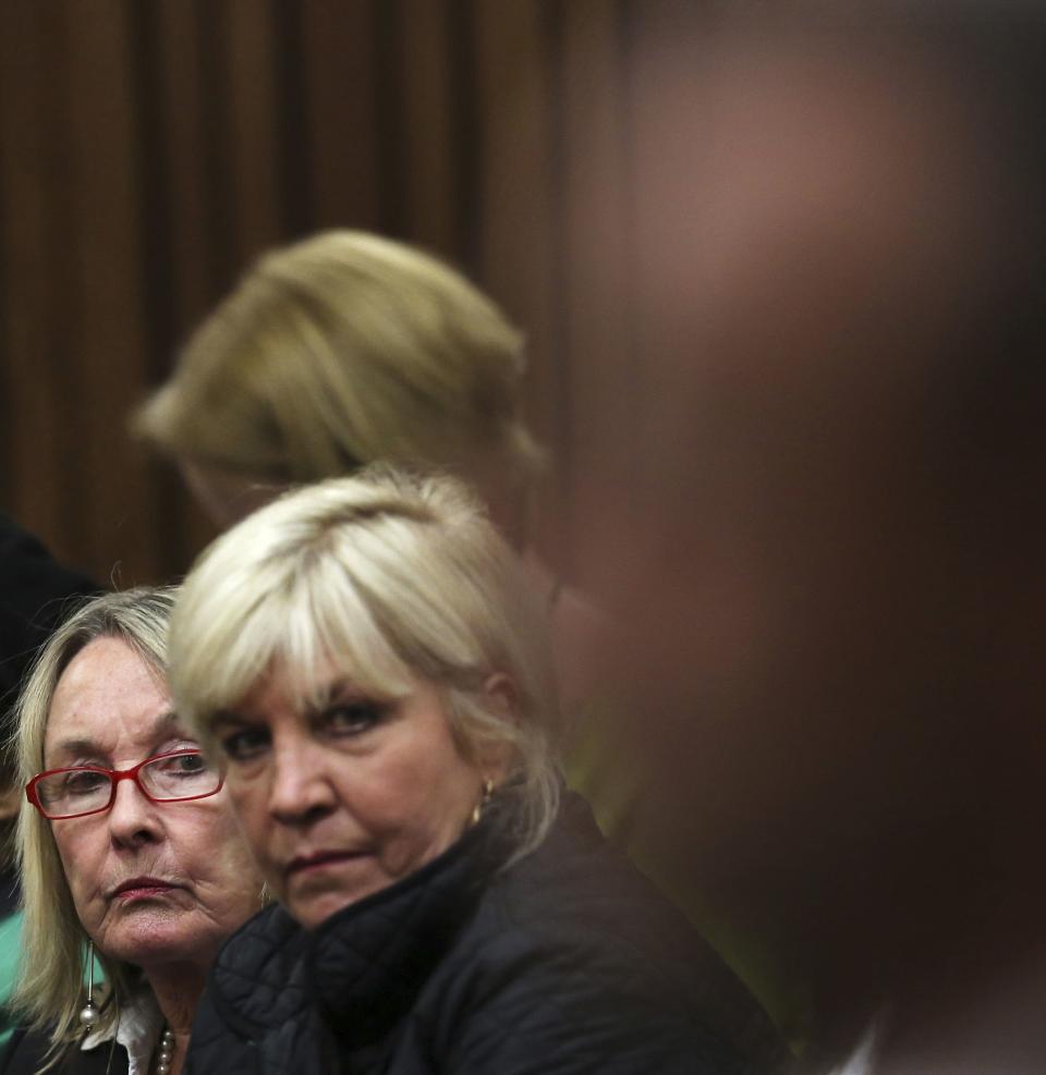 June Steenkamp (L), mother of Reeva Steenkamp, looks on as South African Olympic and Paralympic athlete Oscar Pistorius sits in the dock during his murder trial in the North Gauteng High Court in Pretoria April 17, 2014. Pistorius is on trial for murdering his girlfriend Reeva Steenkamp at his suburban Pretoria home on Valentine's Day last year. REUTERS/Themba Hadebe/Pool (SOUTH AFRICA - Tags: SPORT CRIME LAW ATHLETICS)