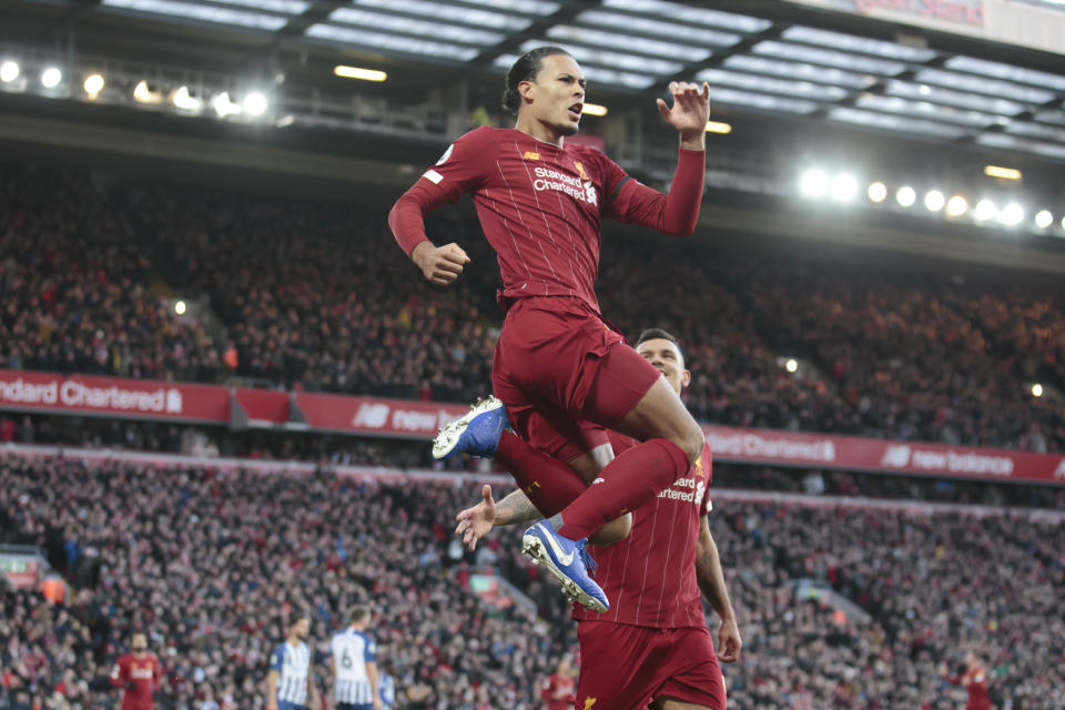 Liverpool's Virgil van Dijk celebrates after scoring during the English Premier League soccer match between Liverpool and Brighton at Anfield Stadium, Liverpool, England, Saturday, Nov. 30, 2019. (AP Photo/Jon Super)