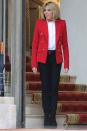 <p>Wearing a white button-up shirt, Alexandre Vauthier red blazer, black skinny pants, and boots at the entrance of the Elysee presidential Palace. </p>