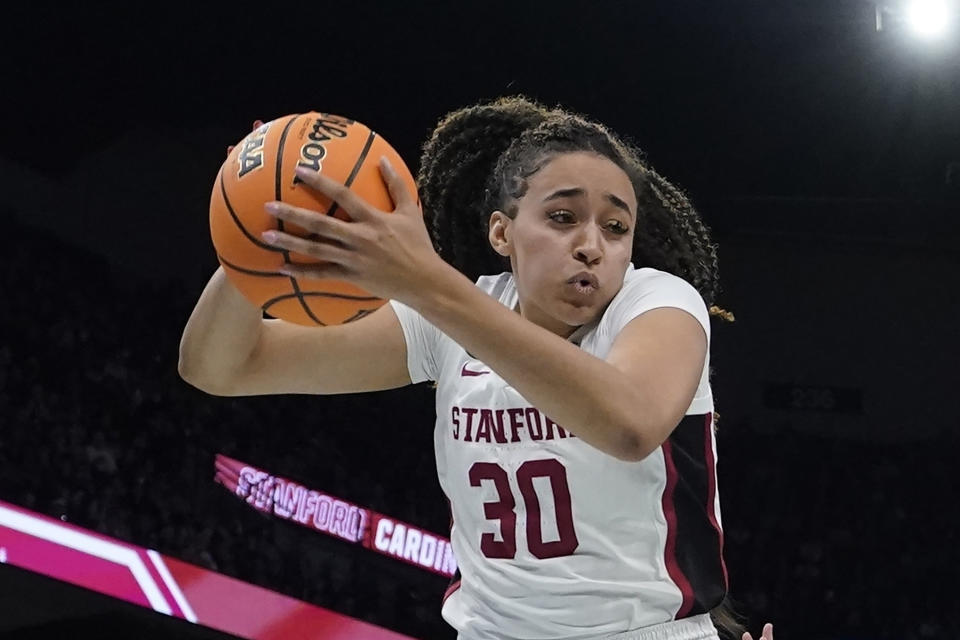 FILE - Stanford's Haley Jones grabs a rebound during the second half of a college basketball game against UConn in the semifinal round of the Women's Final Four NCAA tournament Friday, April 1, 2022, in Minneapolis. Jones was named to the women's Associated Press preseason All-America team, Tuesday, Oct. 25, 2022.(AP Photo/Charlie Neibergall, File)