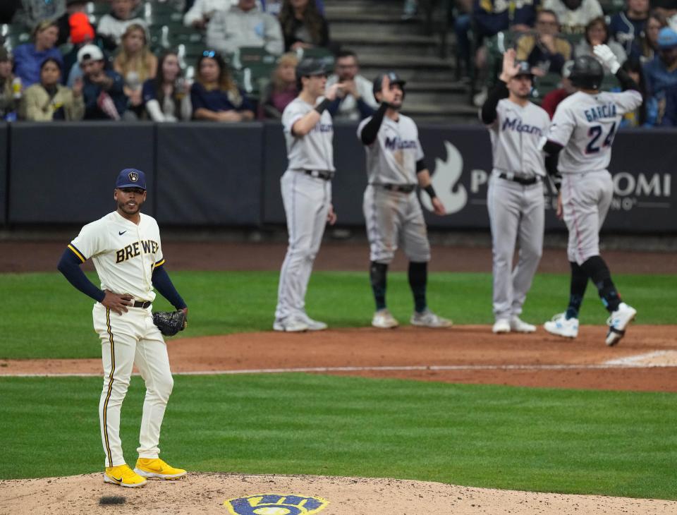 Brewers pitcher Freddy Peralta looks away as Marlins right fielder Avisail Garcia (24) crosses home plate after hitting a grand slam home run during the eighth inning Thursday night at American Family Field.