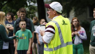 Eaton Rapids Public Schools Superintendent Bill DeFrance, right, chats before a 'Walk a Mile to School' event Thursday, June 12, 2014. The event kicked off a $268,000 grant the city received as part of Michigan's "Safe Routes to School" program.