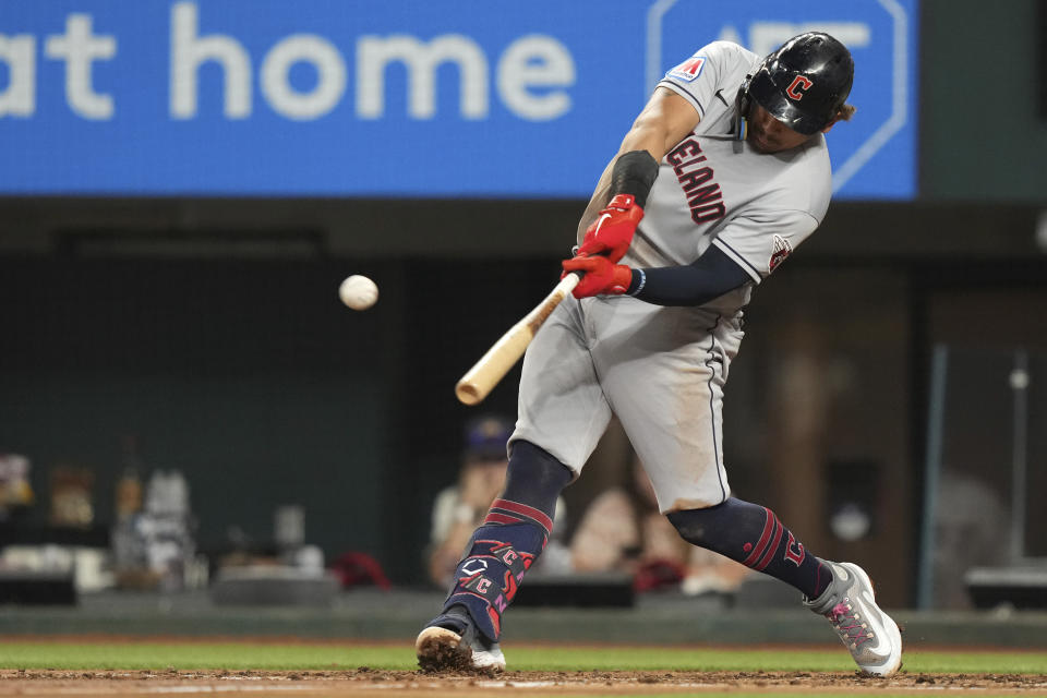 Cleveland Guardians Josh Naylor hits a home run that also scored teammate Myles Straw during the third inning of a baseball game against the Texas Rangers in Arlington, Texas, Friday, July 14, 2023. (AP Photo/LM Otero)