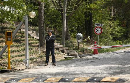 A man stands outside the front gate of Christian Evangelical Baptists of Korea premises in Anseong, south of Seoul April 22, 2014. REUTERS/James Pearson