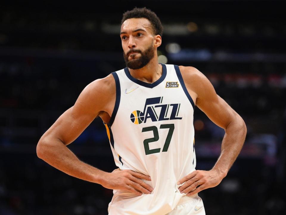 Rudy Gobert stands with his hands on his hips during a game.