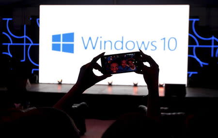 Microsoft delegates take a selfie photograph during the launch of the Windows 10 operating system in Kenya's capital Nairobi, July 29, 2015. REUTERS/Thomas Mukoya