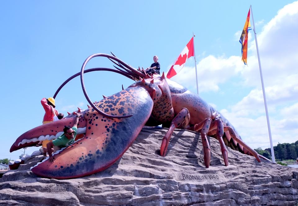 Child site on top of the giant Shediac lobster in New Brunswick. 