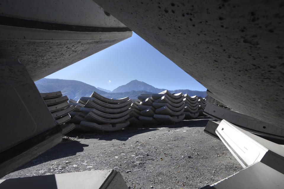 Hundreds of grey stacks of cement slabs lay around a village near Joshimath, in India's Himalayan mountain state of Uttarakhand, Jan. 21, 2023. For months, residents in Joshimath, a holy town burrowed high up in India's Himalayan mountains, have seen their homes slowly sink. They pleaded for help, but it never arrived. In January however, their town made national headlines. Big, deep cracks had emerged in over 860 homes, making them unlivable. (AP Photo/Rajesh Kumar Singh)