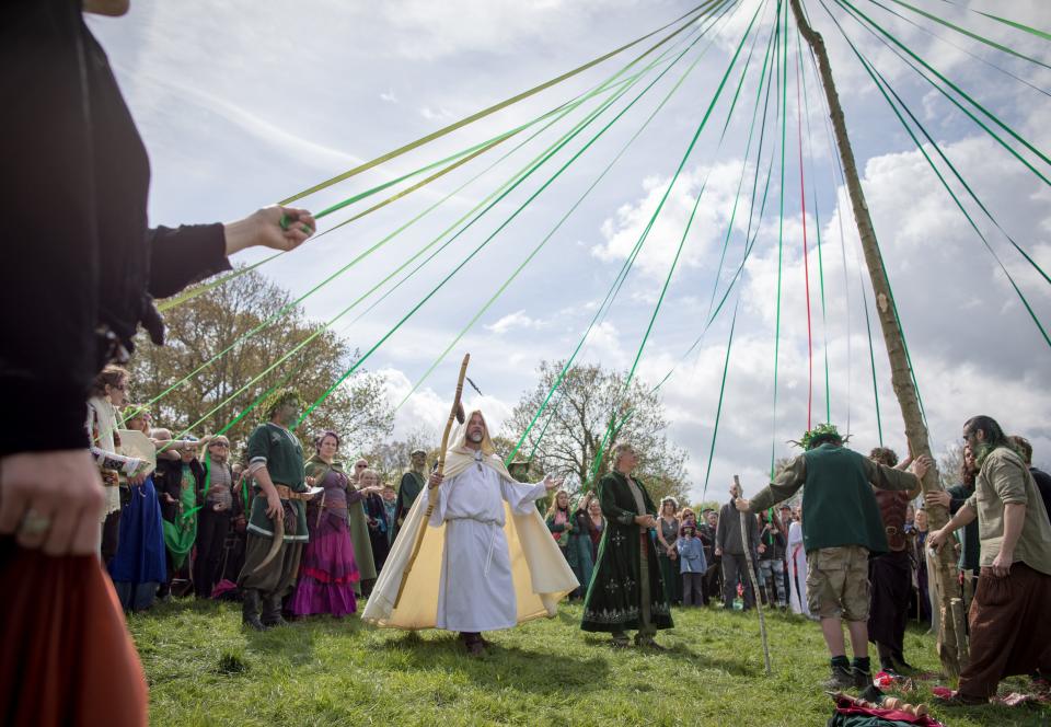 People dance around this year's Maypole at a ceremony at Bushy Combe below Glastonbury Tor in Somerset, England. Although more synonymous with International Workers' Day, or Labour Day, May Day or Beltane is celebrated by druids and pagans as the beginning of summer and the chance to celebrate the coming of the season of warmth and light.