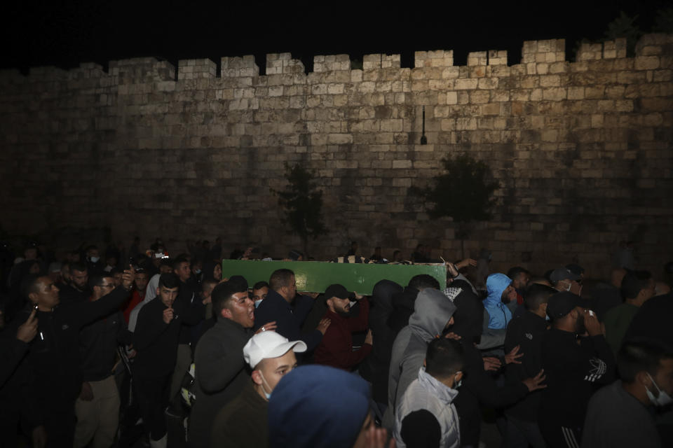 Muslim men carry the body of Iyad Halak to burial after Israeli police shot him dead in Jerusalem's old city, Sunday, May 31, 2020. Israel's defense minister has apologized for the Israeli police's deadly shooting of an unarmed Palestinian man who was autistic. (AP Photo/Mahmoud Illean)