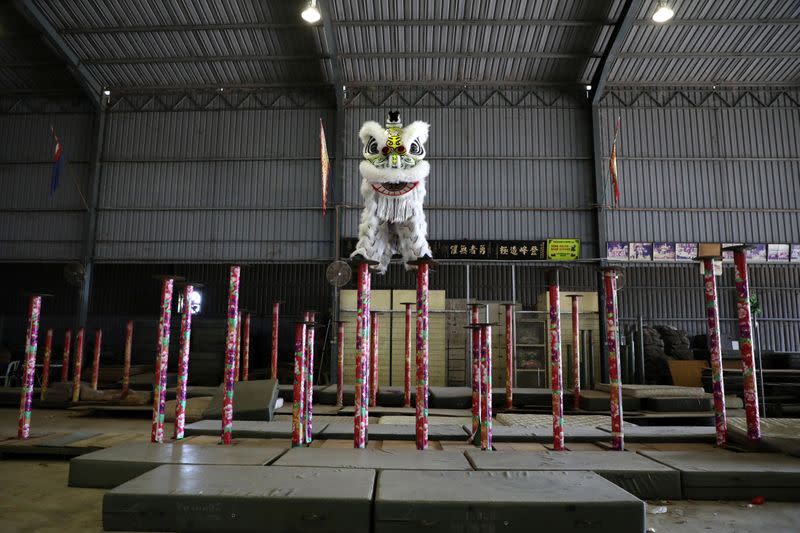 Members of Kun Seng Keng Lion and Dragon Dance Association, demonstrate a traditional Chinese lion dance at a training centre, during an interview with Reuters, in Muar