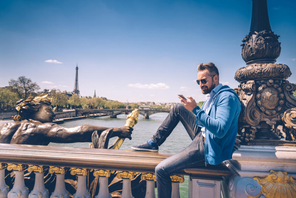 A man who's traveling and using his phone