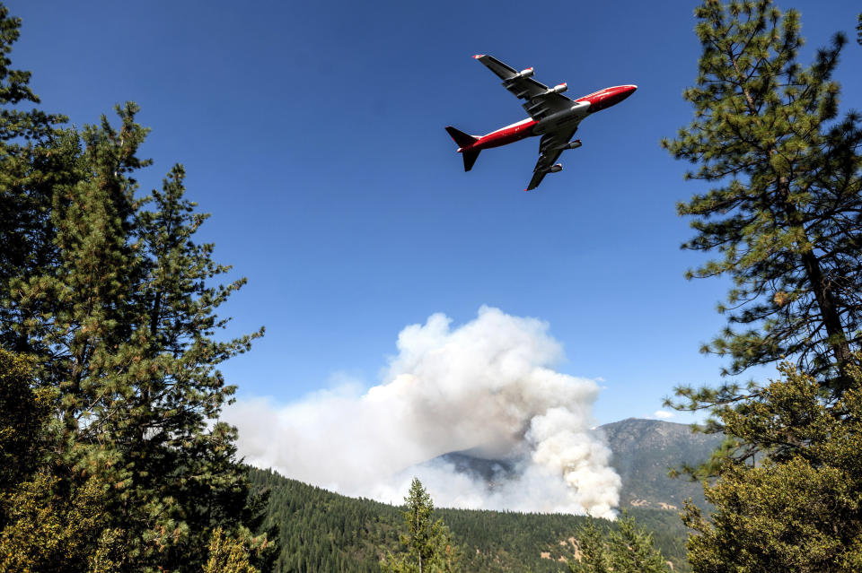 FILE - In this Sept. 17, 2020, file photo, an air tanker prepares to drop retardant while battling the August Complex Fire in the Mendocino National Forest, Calif. Rain showers fell Thursday, Sept. 24, 2020, on the northwestern edges of fire-ravaged California but forecasters warned residents to not be fooled: a new round of hot, dry and windy weather is expected by the weekend. (AP Photo/Noah Berger, File)