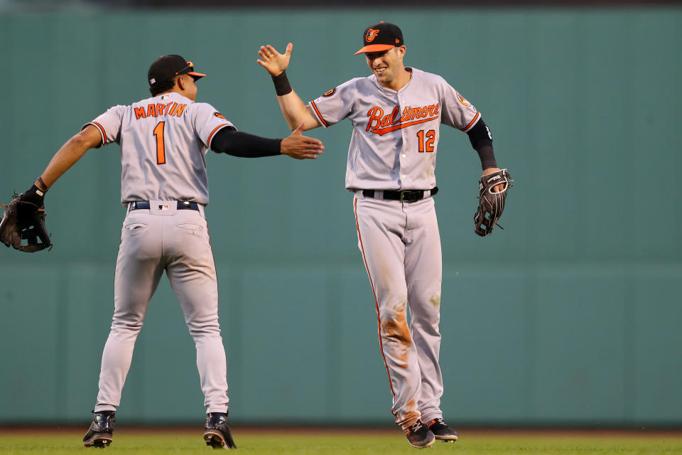 BOSTON, MASSACHUSETTS - SEPTEMBER 29: Stevie Wilkerson #12 of the Baltimore Orioles celebrates with Richie Martin #1 after catching a fly ball from Jackie Bradley Jr. #19 of the Boston Red Sox during the eighth inning at Fenway Park on September 29, 2019 in Boston, Massachusetts. (Photo by Maddie Meyer/Getty Images)