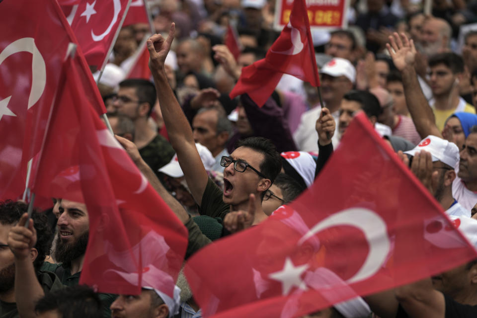 Turkish demonstrators chant slogans while holding Turkish flags during a anti LGBTI+ protest, in Fatih district of Istanbul, Sunday, Sept. 18, 2022. (AP Photo/Khalil Hamra)