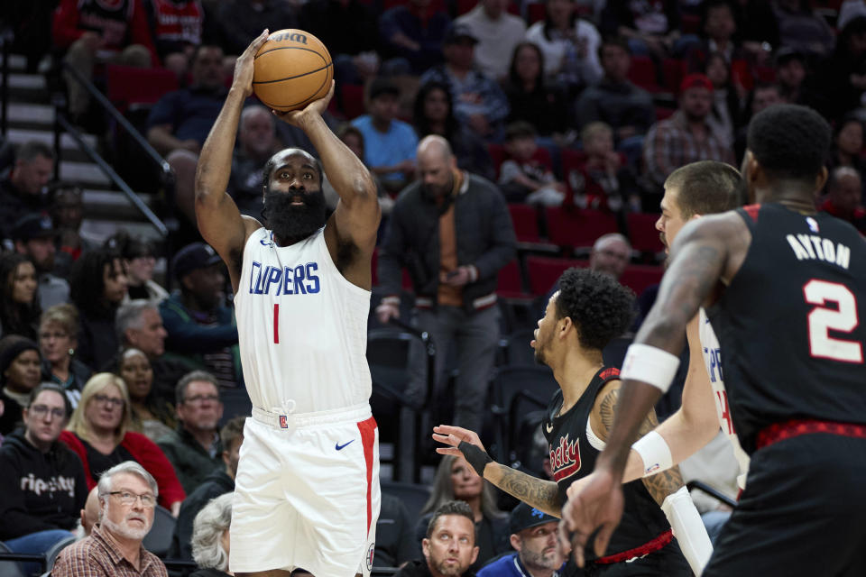 Los Angeles Clippers guard James Harden shoots next to Portland Trail Blazers guard Anfernee Simons during the first half of an NBA basketball game in Portland, Ore., Wednesday, March 20, 2024. (AP Photo/Craig Mitchelldyer)
