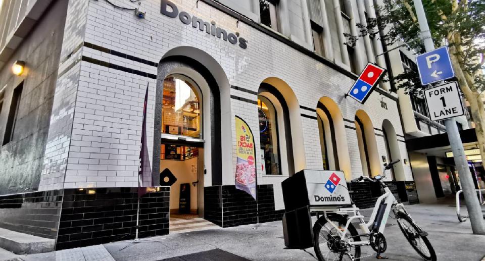 Domino's pizza delivery bike parked in front of store in Brisbane city