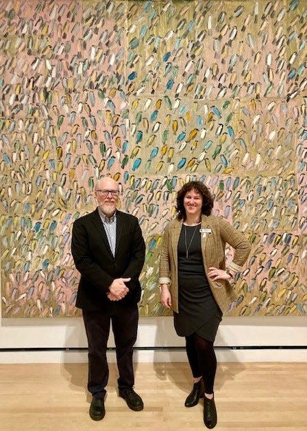 Two of the three exhibit curators, Harry Delorme and Erin Dunn, stand before the show's largest work, "Migration," by Hunt Slonem, 2004, oil on canvas, image Josephine Johnson