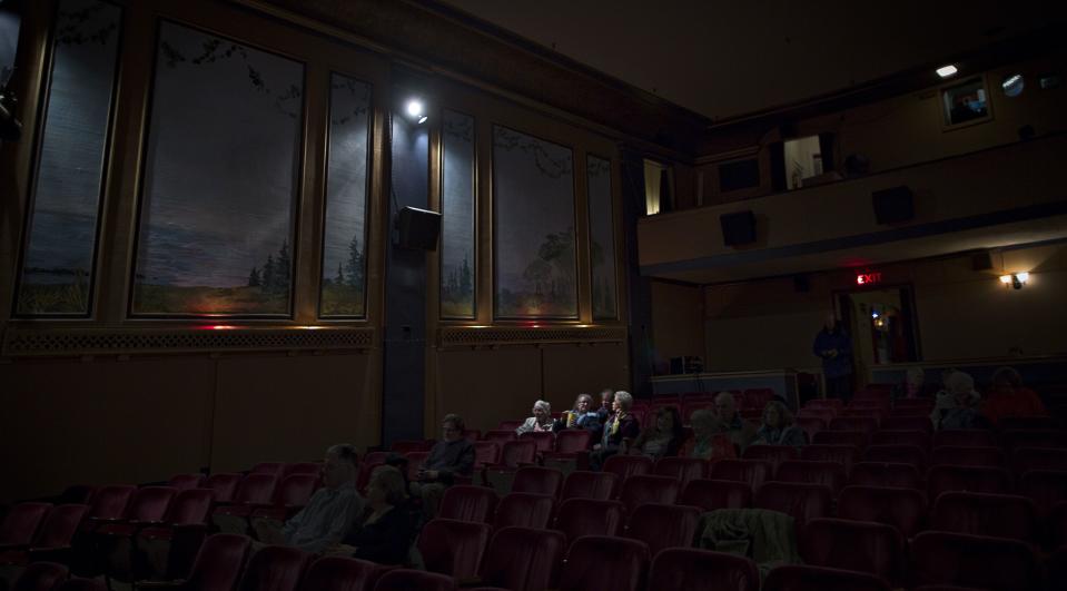 The audience waits for an evening screening of the 1952 movie "Singing in the Rain". Even though the one-screen theatre generally shows the recent releases they do sometimes show old classics. (Reuters)