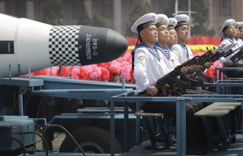 FILE - In this April 15, 2017, file photo, navy personnel sit in front of a submarine-launched "Pukguksong" ballistic missile (SLBM) as it is paraded across Kim Il Sung Square in Pyongyang, North Korea. North Korea could soon conduct its first underwater-launched ballistic missile test in about a year, South Korea's military said Wednesday, Sept. 16, 2020, amid long-stalled nuclear talks between the North and the United States. (AP Photo/Wong Maye-E, File)