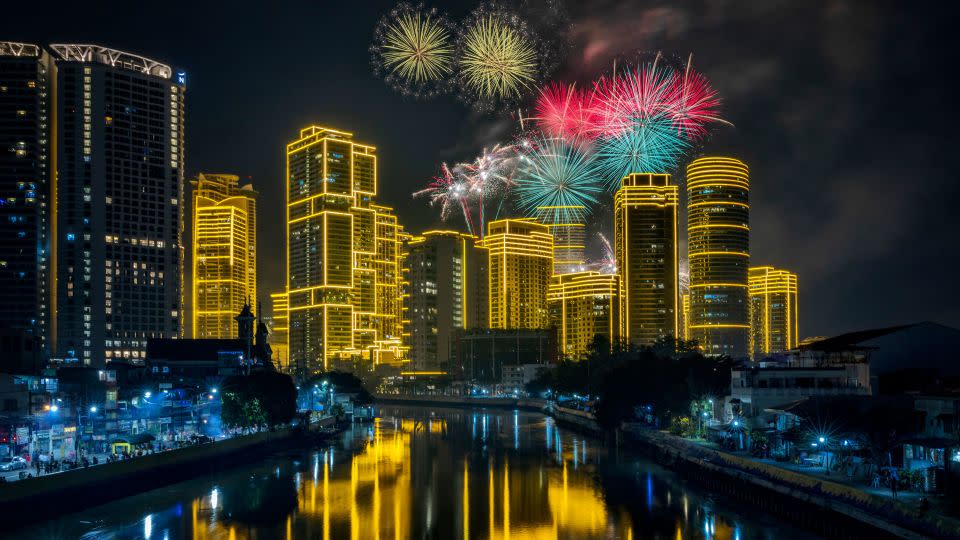 Fireworks explode over buildings during New Year's celebrations on January 01, 2023 in Makati, Metro Manila, Philippines. - Ezra Acayan/Getty Images