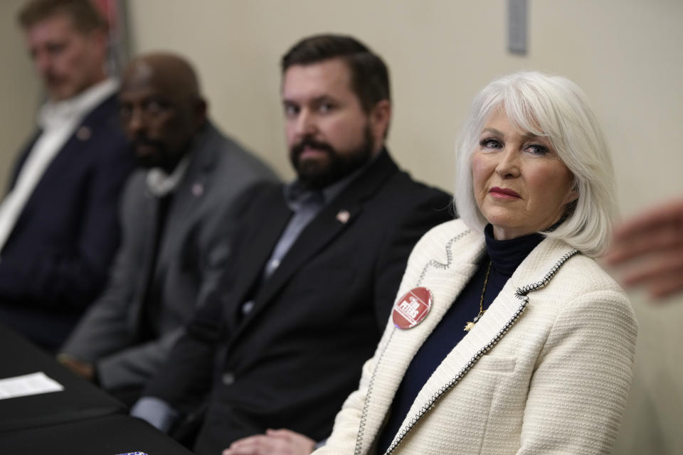 Candidate for the Colorado Republican Party chair position Tina Peters, right, and fellow candidates from left, Erik Aadland, Casper Stockham and Aaron Wood, listen during a debate sponsored by the Republican Women of Weld, Saturday, Feb. 25, 2023, in Hudson, Colo. (AP Photo/David Zalubowski)