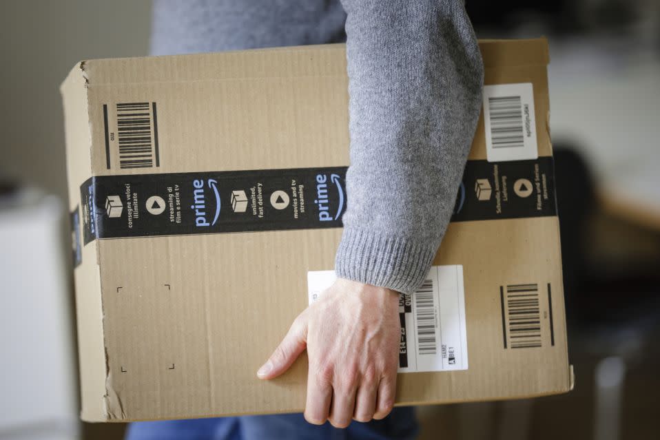 Berlin, Germany - March 20: A man is holding an Amazon Prime package on March 20, 2018 in Berlin, Germany. (Photo by Thomas Trutschel/Photothek via Getty Images)