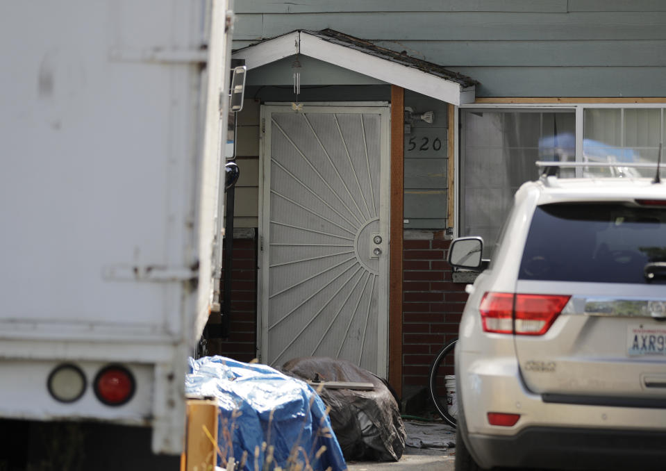 Vehicles are parked outside the home of Paige A. Thompson, who uses the online handle "erratic," Wednesday, July 31, 2019, in Seattle. Thompson was taken into custody Monday at her home and has been charged with computer fraud and abuse in connection with hacking data from more than 100 million Capital One credit holders or applicants. (AP Photo/Ted S. Warren)