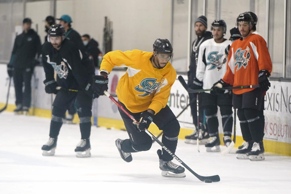 San Jose Barracuda's Evander Kane, middle, skates during a hockey practice in San Jose, Calif., Tuesday, Nov. 30, 2021. Kane reported to the San Jose Sharks' minor league affiliate for the first time since serving a suspension for submitting a fake COVID-19 vaccination card. (AP Photo/Jeff Chiu)