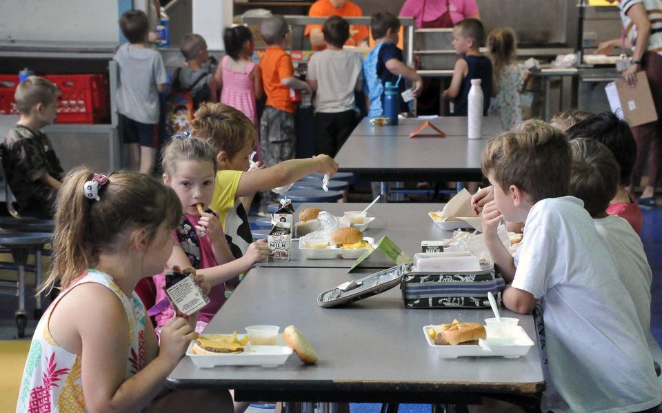 Students sit and eat their lunches at Cornerstone Elementary School Monday, June 6 on the first day of the Wooster City Schools summer lunch program. Wooster City Schools Food Service Manager Don Lewis said students in Wooster can get meals at Cornerstone, Edgewood, Wooster High School and the local YMCA throughout the summer.