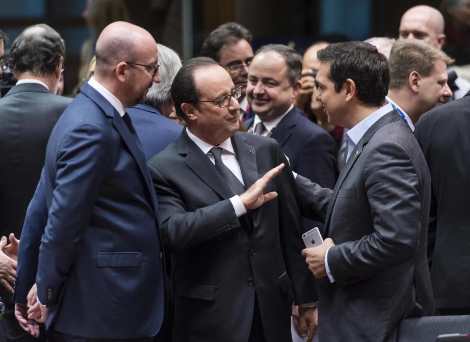 French President Francois Hollande, center, speaks with Greek Prime Minister Alexis Tsipras, right, and Belgian Prime Minister Charles Michel, left, during a round table meeting at an EU Summit in Brussels on Thursday, Dec. 15, 2016. European Union leaders meet Thursday in Brussels to discuss defense, migration, the conflict in Syria and Britain's plans to leave the bloc. (AP Photo/Geert Vanden Wijngaert)