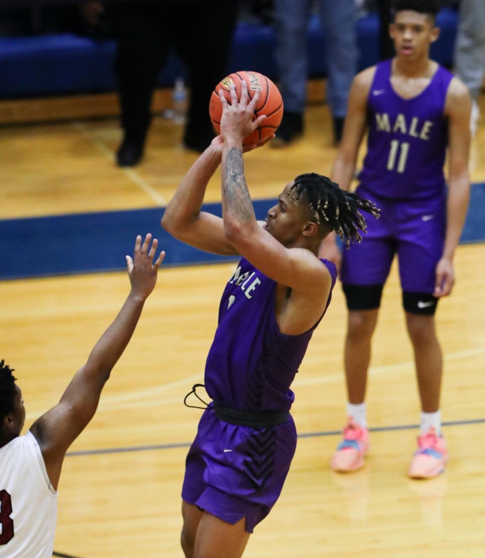 Male’s Kaleb Glenn (1) squares up to hit the game-winning shot to defeat Ballard 82-80 in the Seventh Region final at the Valley High School gymnasium in Louisville, Ky. on Mar. 7, 2022.  