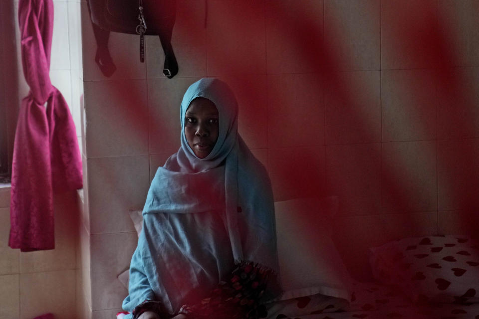 Majdah Ishag, from Sudan, sits for a photograph in her room at a hotel turned into a shelter for refugees in Batam, an island in northwestern Indonesia, Thursday, May 16, 2024. Ishag has been at the community housing for eight years while waiting for resettlement in a third country. (AP Photo/Dita Alangkara)