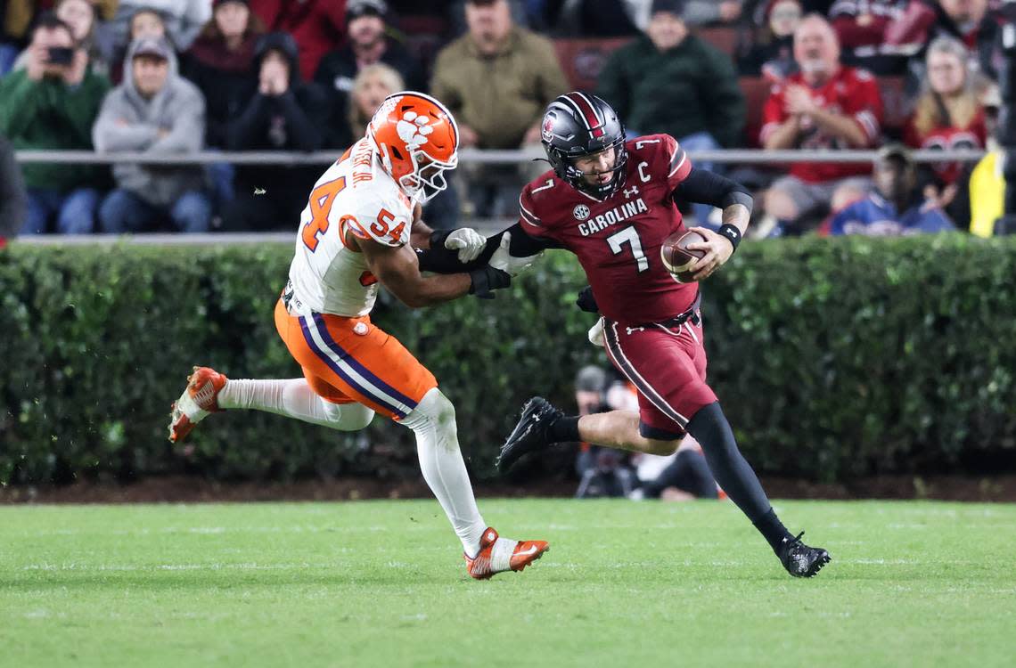 South Carolina quarterback Spencer Rattler (7) is chased down by Clemson linebacker Jeremiah Trotter Jr. (54) during the second half of South Carolina’s game against Clemson at Williams-Brice Stadium in Columbia on Saturday, November 25, 2023.