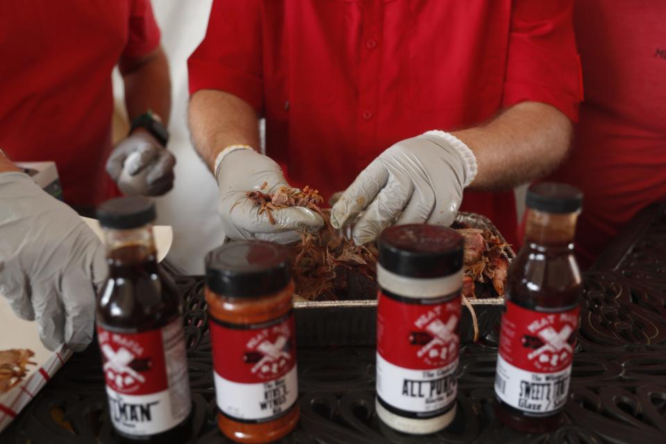 Pork shoulder is pulled apart by Bryan Bruce from Mississippi Meat Mafia as the team prepares to serve to judges on May 18, 2023, during the Memphis in May World Championship Barbecue Cooking Contest at Tom Lee Park in Downtown Memphis.