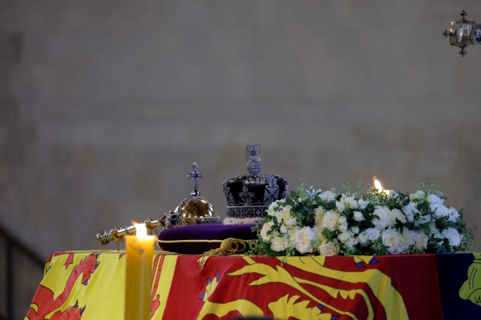 The coffin of Queen Elizabeth, draped in the Royal Standard with the Imperial State Crown and the Sovereign's orb and sceptre, on the catafalque inside Westminster Hall (AP)