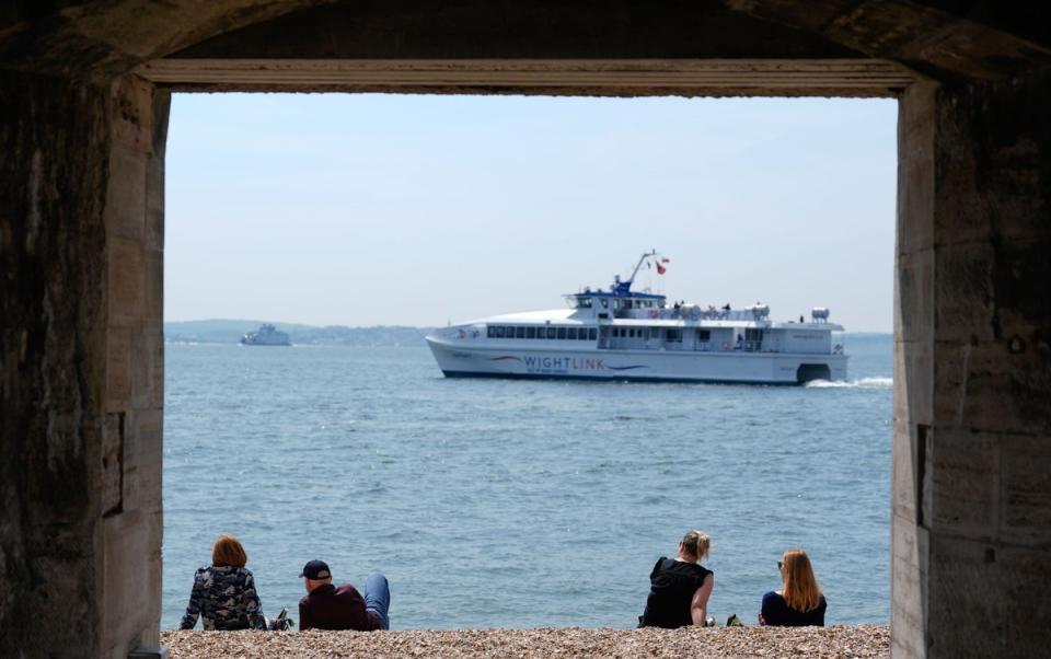 People enjoy the warm weather on Hotwalls Beach, Portsmouth (Andrew Matthews/PA Wire)