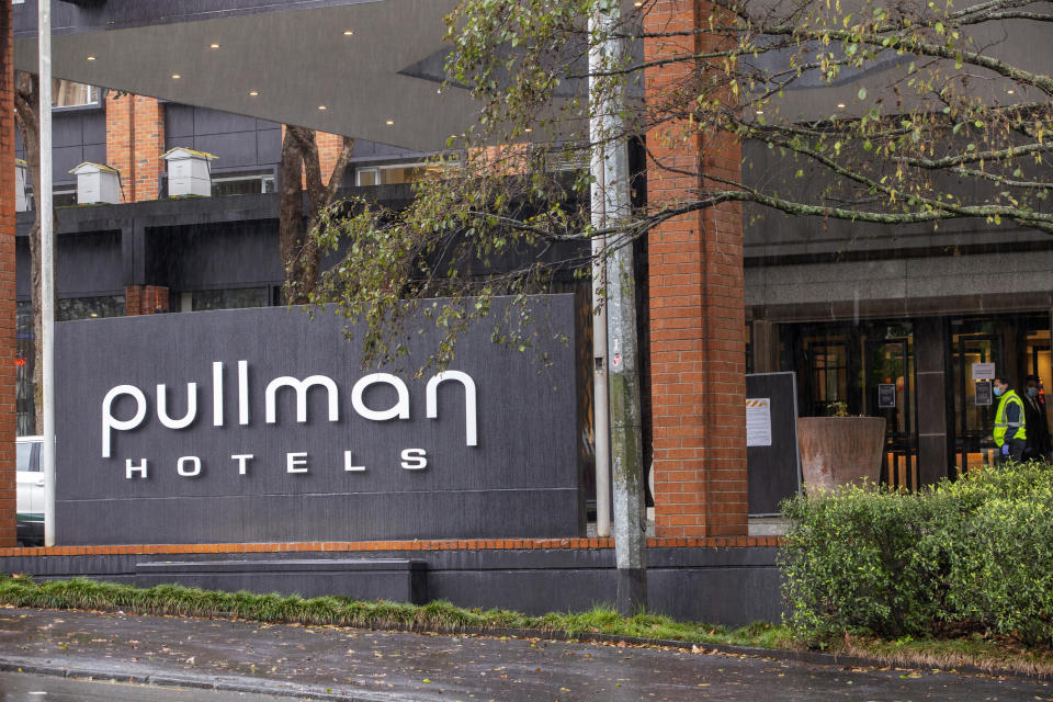Security patrol outside the Pullman Hotel in Auckland, New Zealand, July 6, 2020. Health officials in New Zealand say Monday, Jan. 25, 2021, that genome tests indicate the country's most recent COVID-19 patient contracted the virus from another returning traveler just before leaving quarantine. (Peter Meecham/New Zealand Herald via AP)