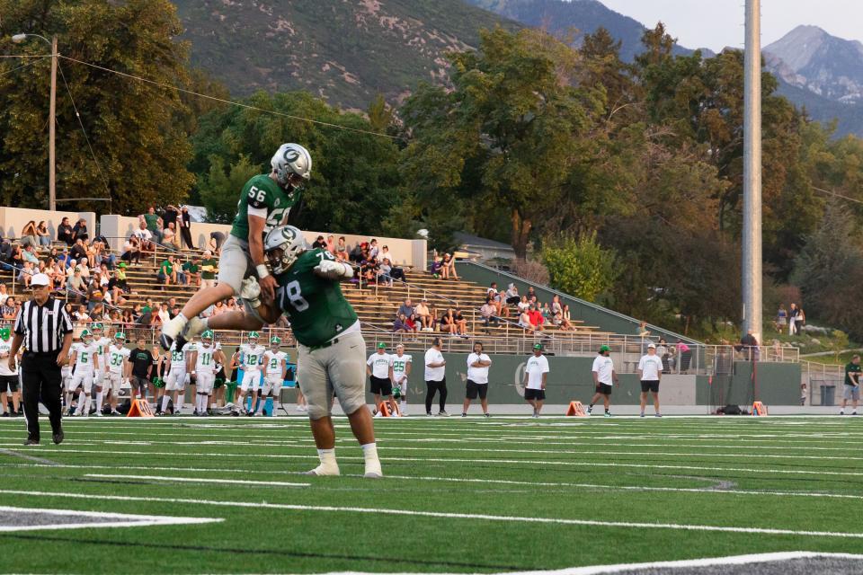 Olympus football players celebrate after Chase Moseley’s touchdown in their high school football game against Provo at Olympus High School in Holladay on Friday, Aug. 18, 2023. | Megan Nielsen, Deseret News