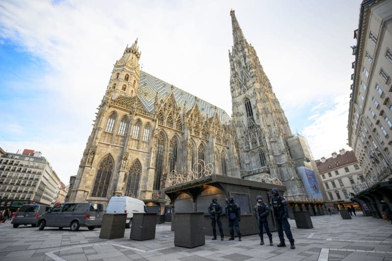 Police officers stand in front of St. Stephen's Cathedral following indications of a possible attack plan by a terrorist group. According to the Austrian Ministry of the Interior, the Austrian Office for the Protection of the Constitution has arrested four people in an investigation into a terrorist network. Max Slovencik/APA/dpa