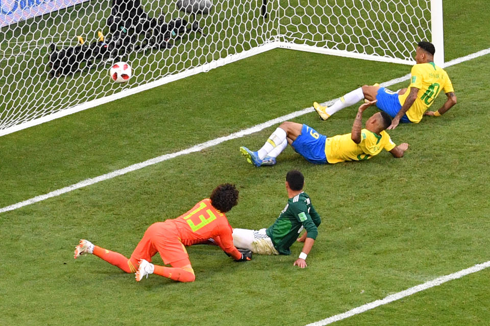  On the spot: Neymar slides to score for Brazil in the 50th minute. (SAEED KHAN/AFP/Getty Images)