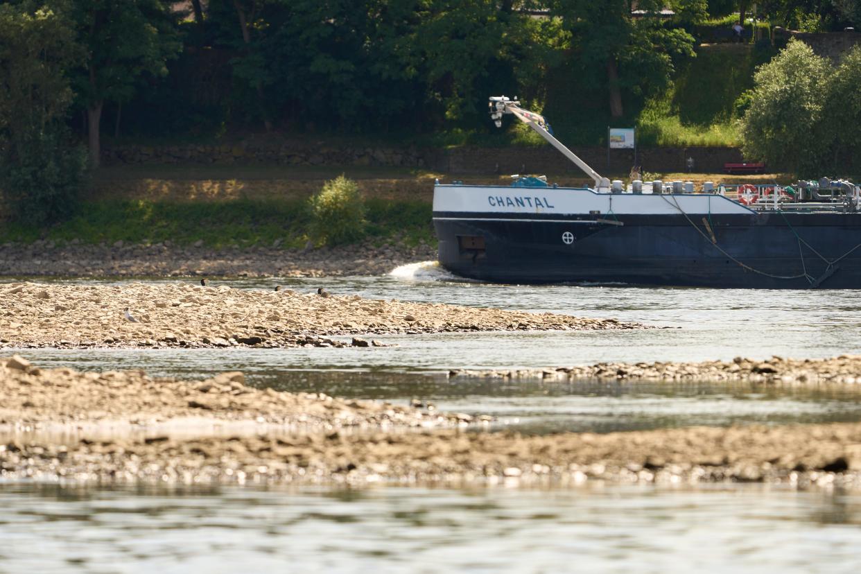 A cargo ship passes a sandbank near Bendorf on the Rhine. In the continuing drought of midsummer, the water level of the Middle Rhine continues to fall. Not all inland vessels can still load fully. July 18 2022