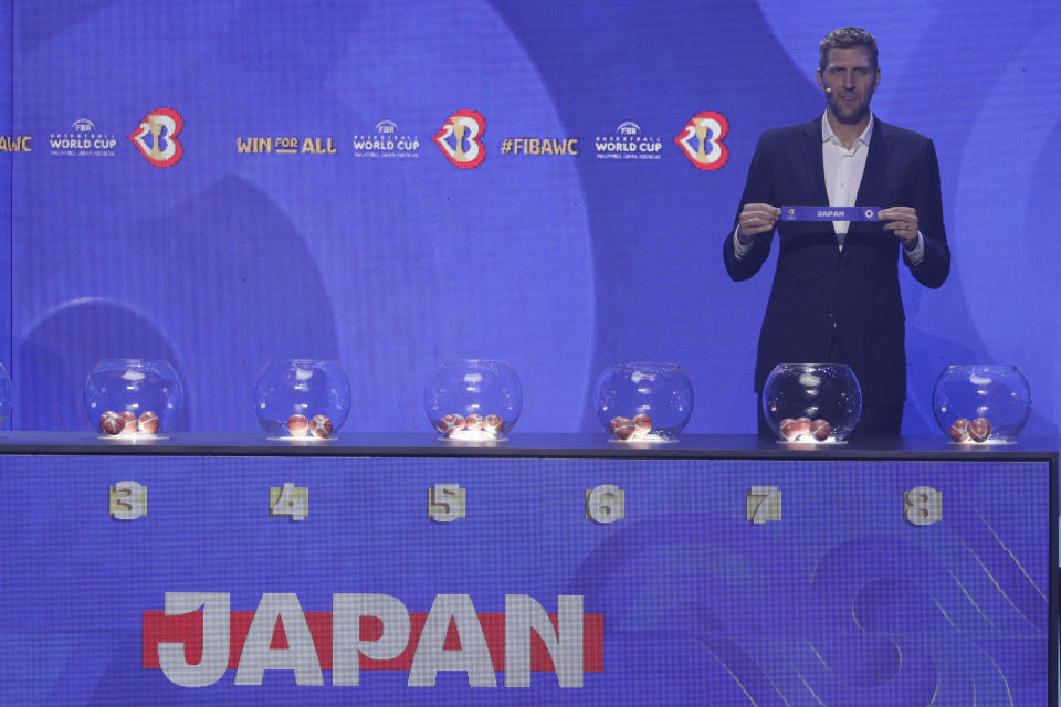 German former NBA basketball player Dirk Nowitzki shows the ticket for Japan national basketball team during the FIBA World Cup 2023 draw in Quezon city, Philippines on Saturday April 29, 2023. (AP Photo/Josefino de Guzman)