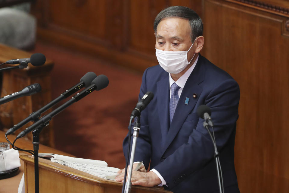 Japanese Prime Minister Yoshihide Suga delivers a policy speech during an extraordinary Diet session at the upper house of parliament in Tokyo, Monday, Oct. 26, 2020. Suga has declared Japan will achieve zero carbon emissions by 2050 in his first policy speech after taking over from Shinzo Abe. The policy speech Monday at the outset of the parliamentary session set an ambitious agenda reflecting Suga's pragmatic approach to getting things done. (AP Photo/Koji Sasahara)